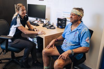 Exercise Physiologist consults with patient at desk